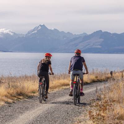 Bike riding in font of mountain and water
