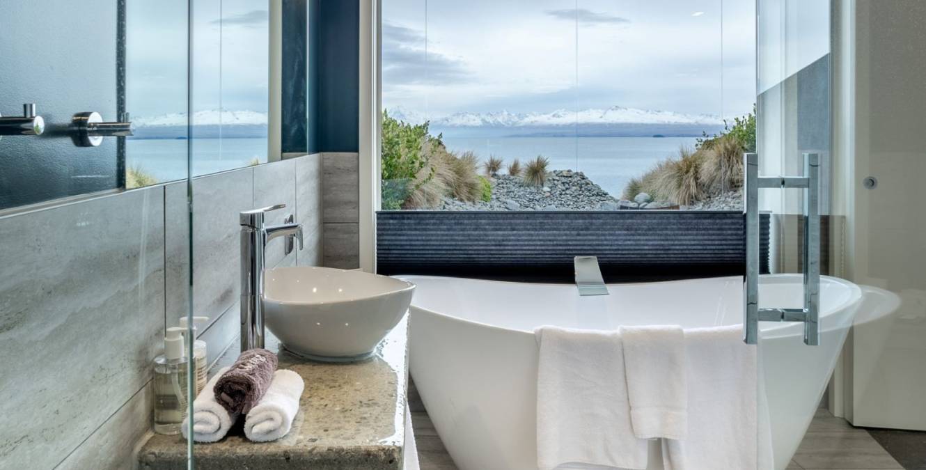 Freestanding soaking bath in the Lake View Super King Room overlooking Lake Pukaki.