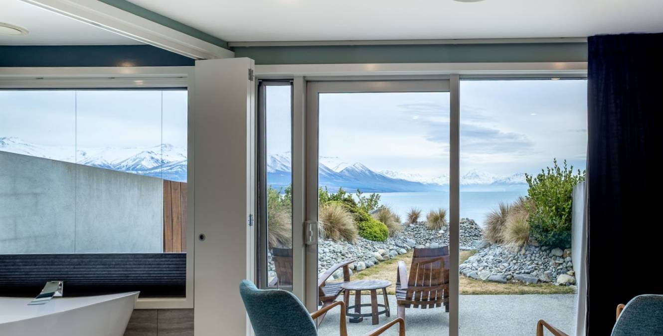 Sitting area and private courtyard outside the Lake View Super King Room overlooking Lake Pukaki and Aoraki Mt Cook.