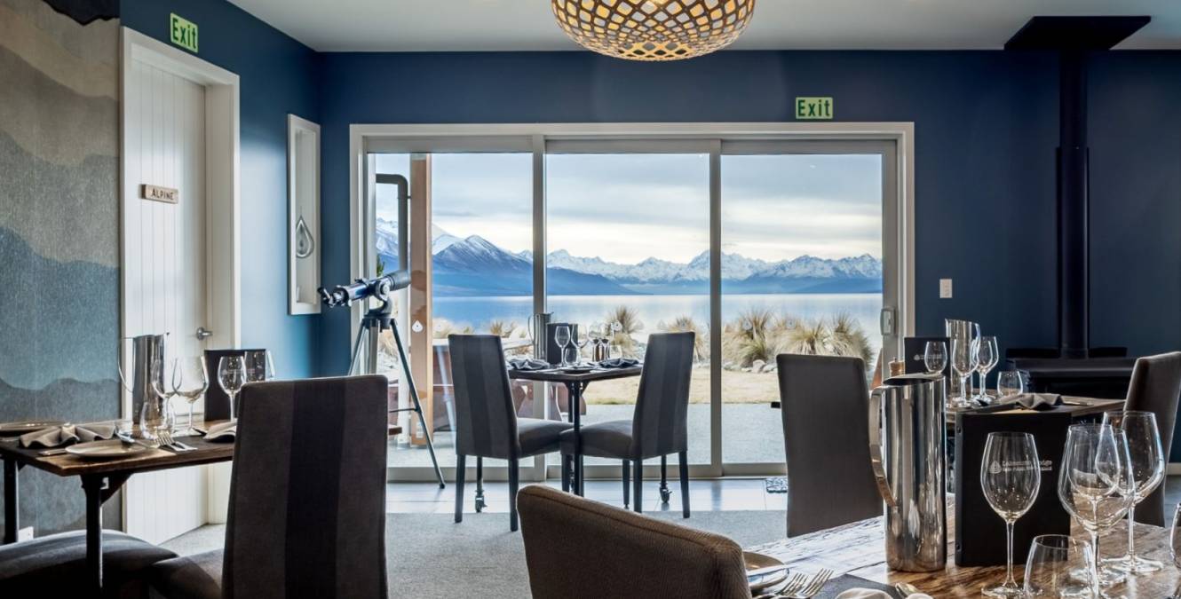 Dining room at Lakestone Lodge overlooking Lake Pukaki and the Southern Alps, where guests enjoy dinner and breakfast
