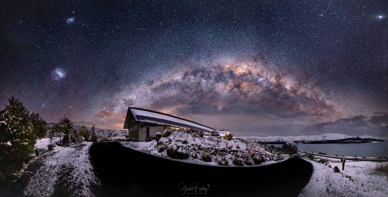 The Milky Way shining brightly over Lakestone Lodge in winter, with snow-covered landscapes and views