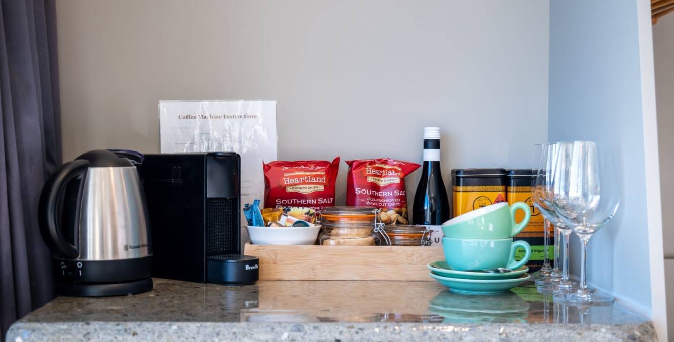 Complimentary minibar in the Lake View Spa Suite with espresso coffee machine, tea selection, snacks and beer and wine